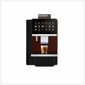 Dr Coffee F16 coffee machine, front view with touchscreen, blue-lit dispensing spout and a glass of latte.