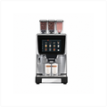 A modern automatic espresso machine with a stainless steel and black body, featuring a large touch screen and two glass cups filled with coffee on the drip tray, set against a plain white background.