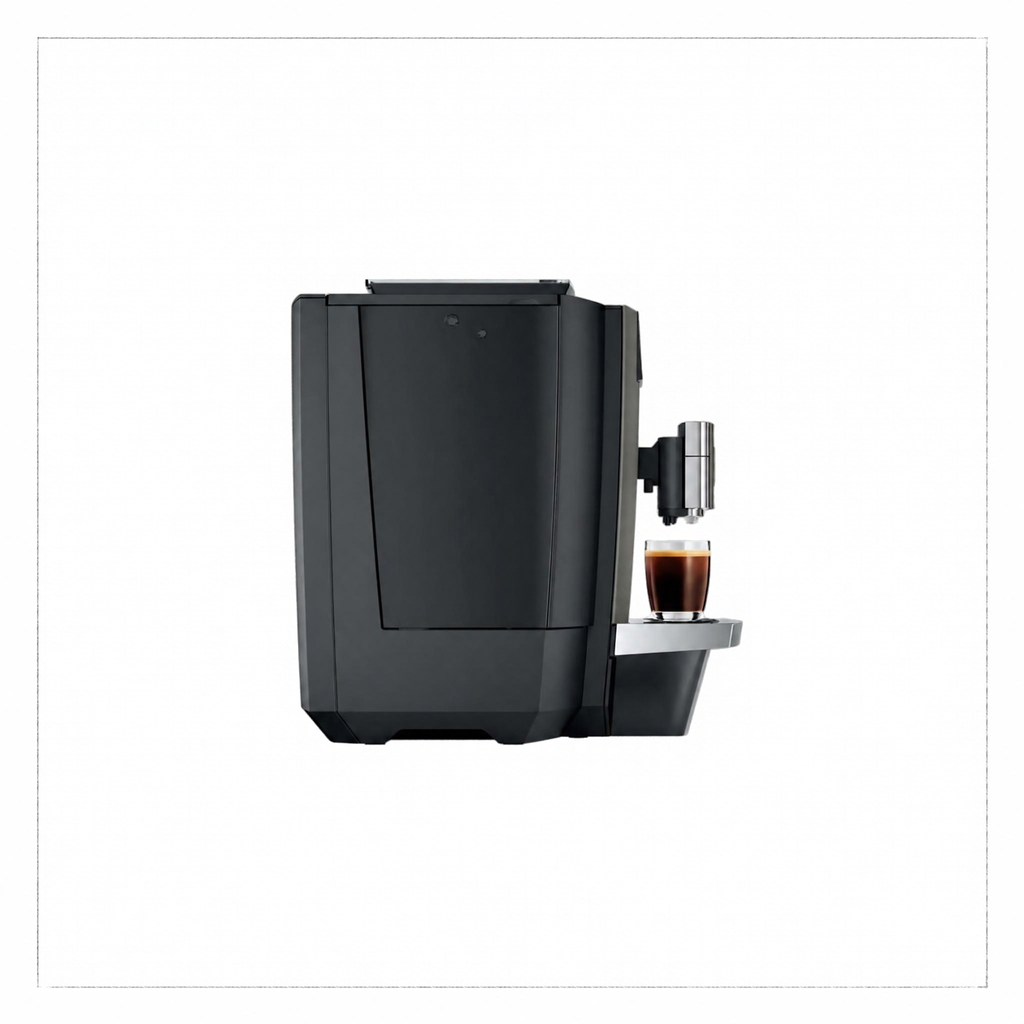 A sleek black coffee machine with a small glass cup of espresso on its drip tray, shown against a plain white background.