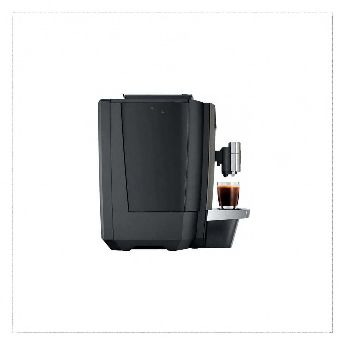 A sleek black coffee machine with a small glass cup of espresso on its drip tray, shown against a plain white background.
