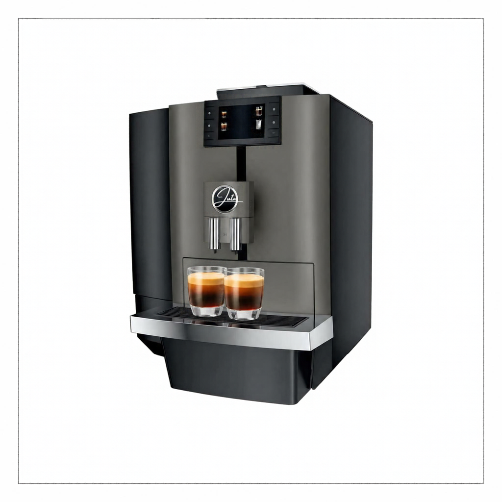 A modern semi-automatic espresso machine in dark gray and black, shown with two freshly brewed espresso cups on its drip tray against a plain white background.